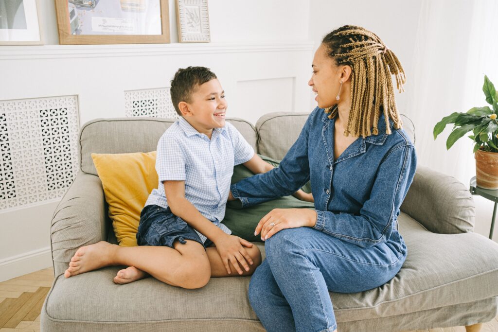 parent talking with a child on the couch