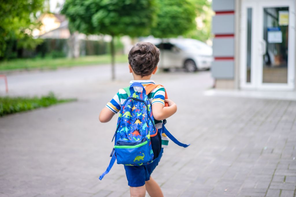 Boy running with backpack to private school