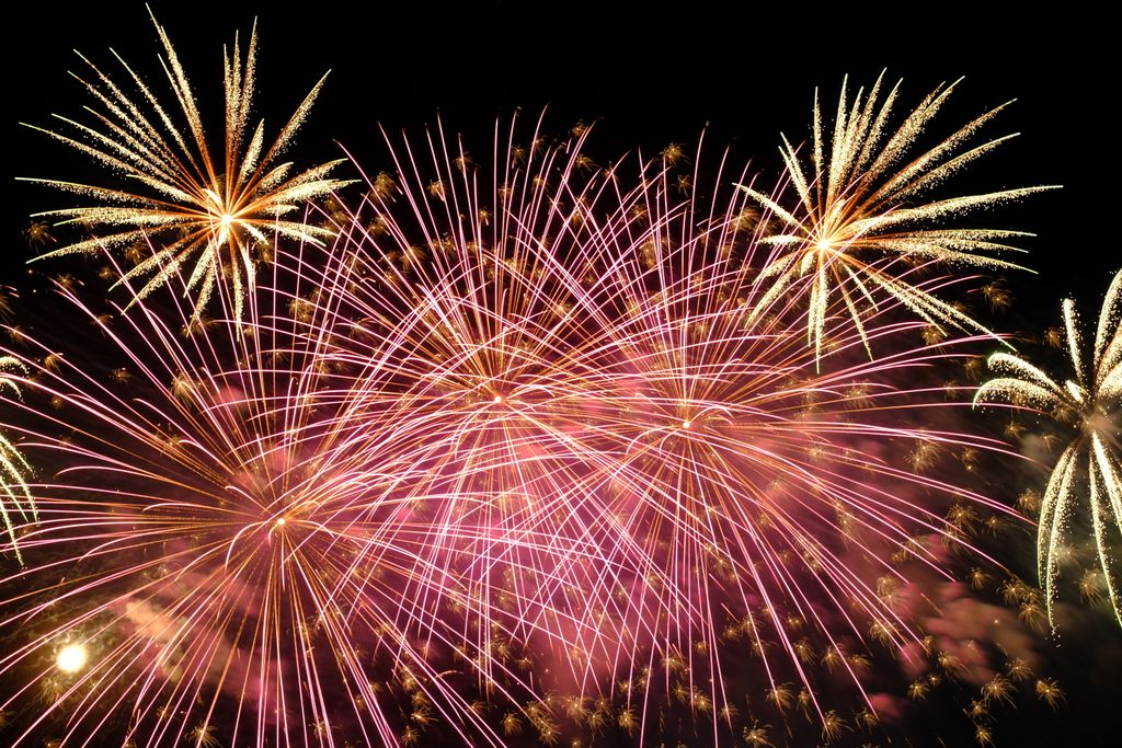 Bursting fireworks illuminate the night sky with vivid colors in Roanoke Va