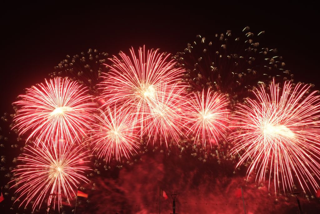 Dazzling fireworks burst in the night sky, creating a vibrant spectacle.
