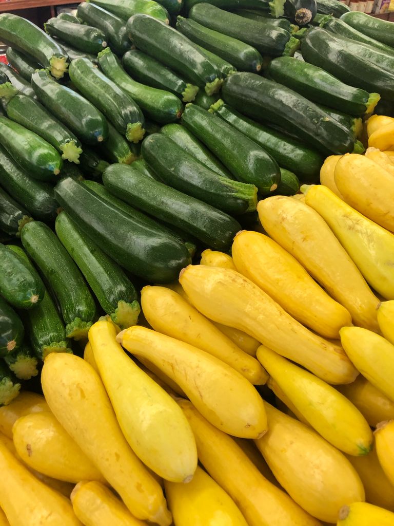 Vibrant display of fresh green zucchini and yellow squash at a farmer's market Roanoke Va