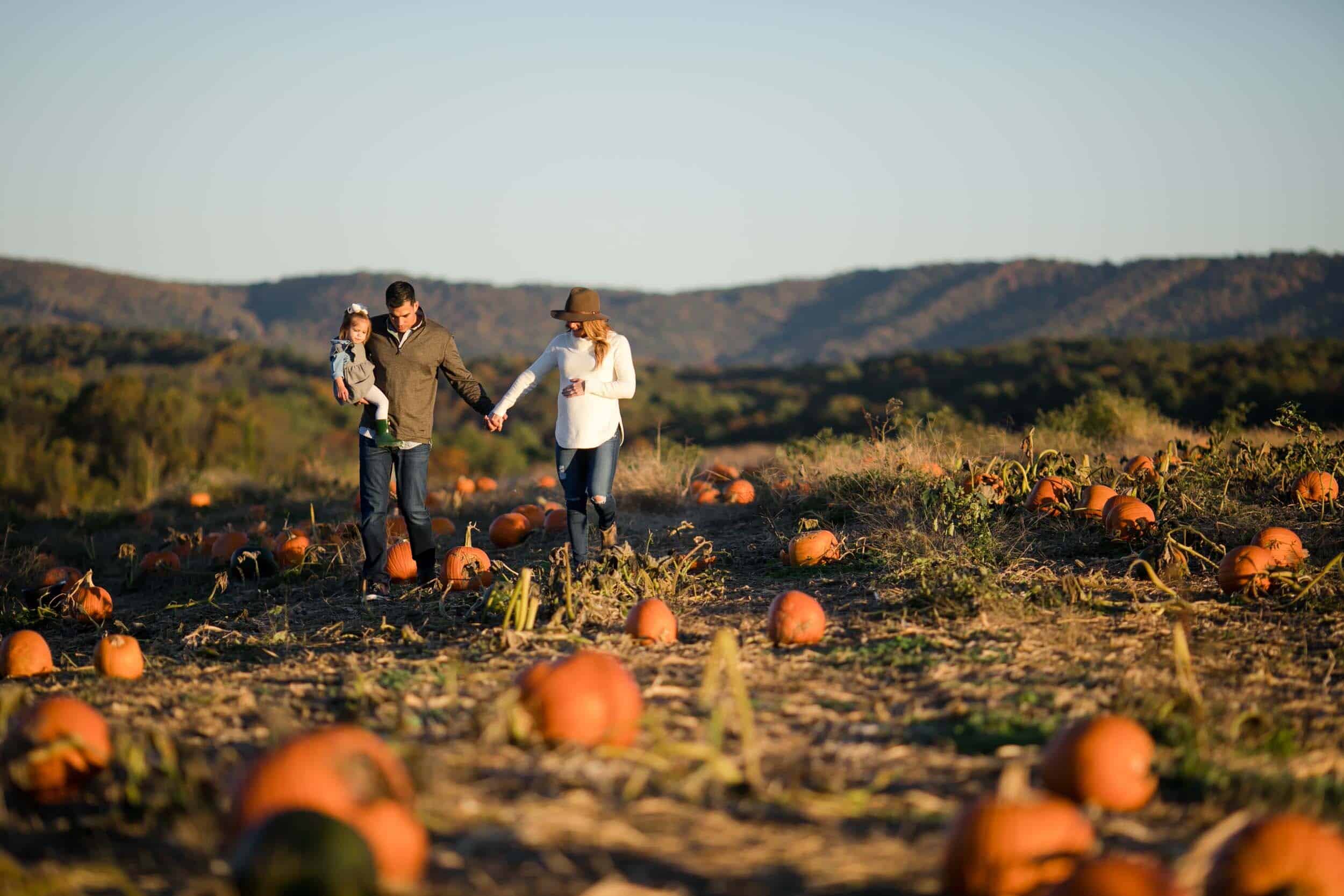 Family walks through pumpkin patch at Sinkland Farms Pumpkin Festival in Roanoke, VA