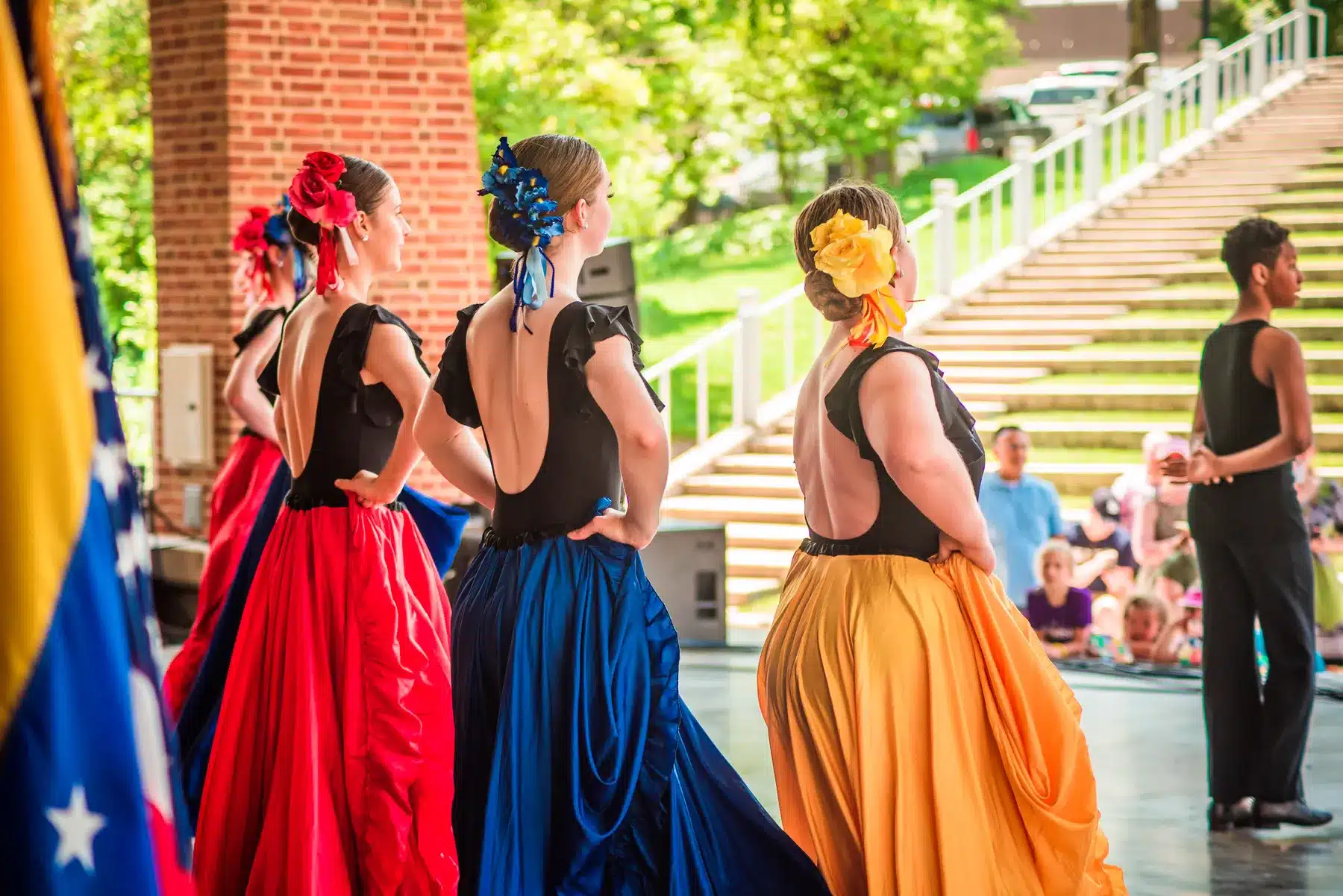 Women dancing in colorful dresses at Roanoke's Hispanic Heritage Festival